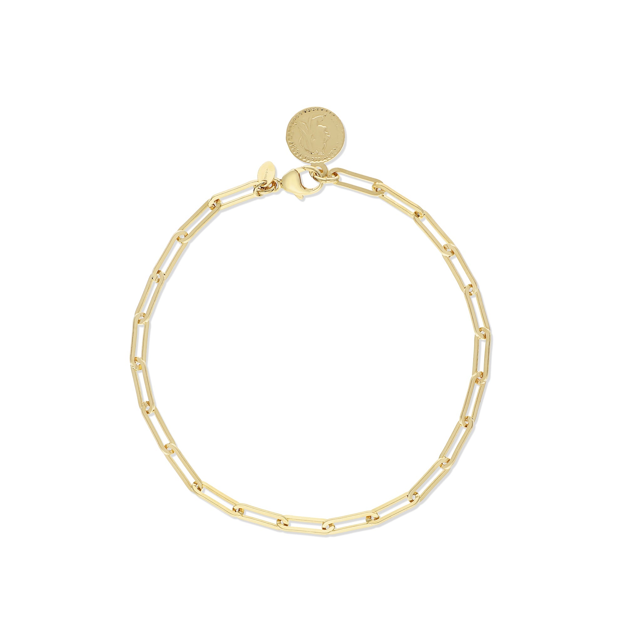 Close-up of a gold chain bracelet with intricate interlocking links, featuring a shiny finish and a decorative charm attached.