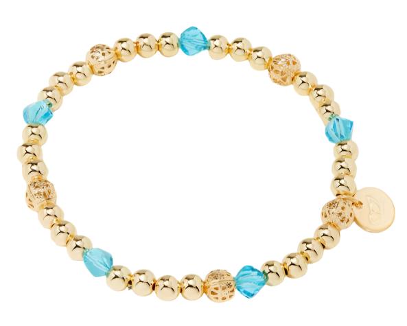 Gold bead bracelet featuring alternating shiny gold beads, decorative gold filigree beads, and blue crystal beads, finished with a small charm for added detail.