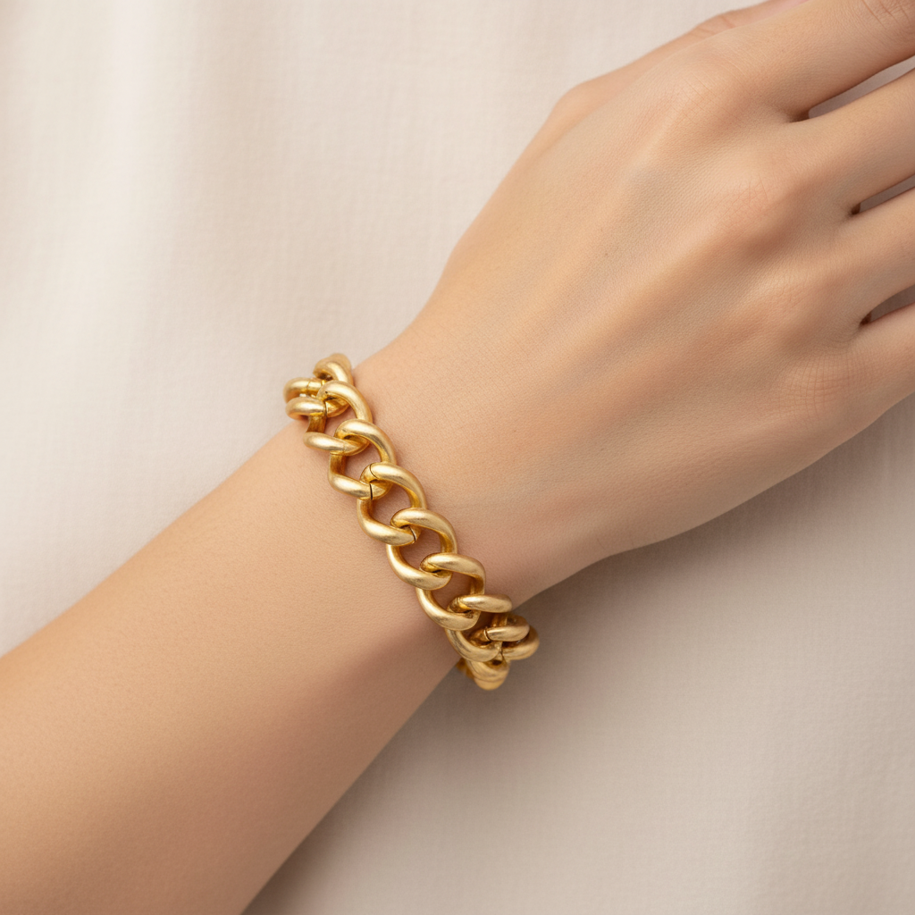 Bold chunky gold chain link bracelet on model's wrist
