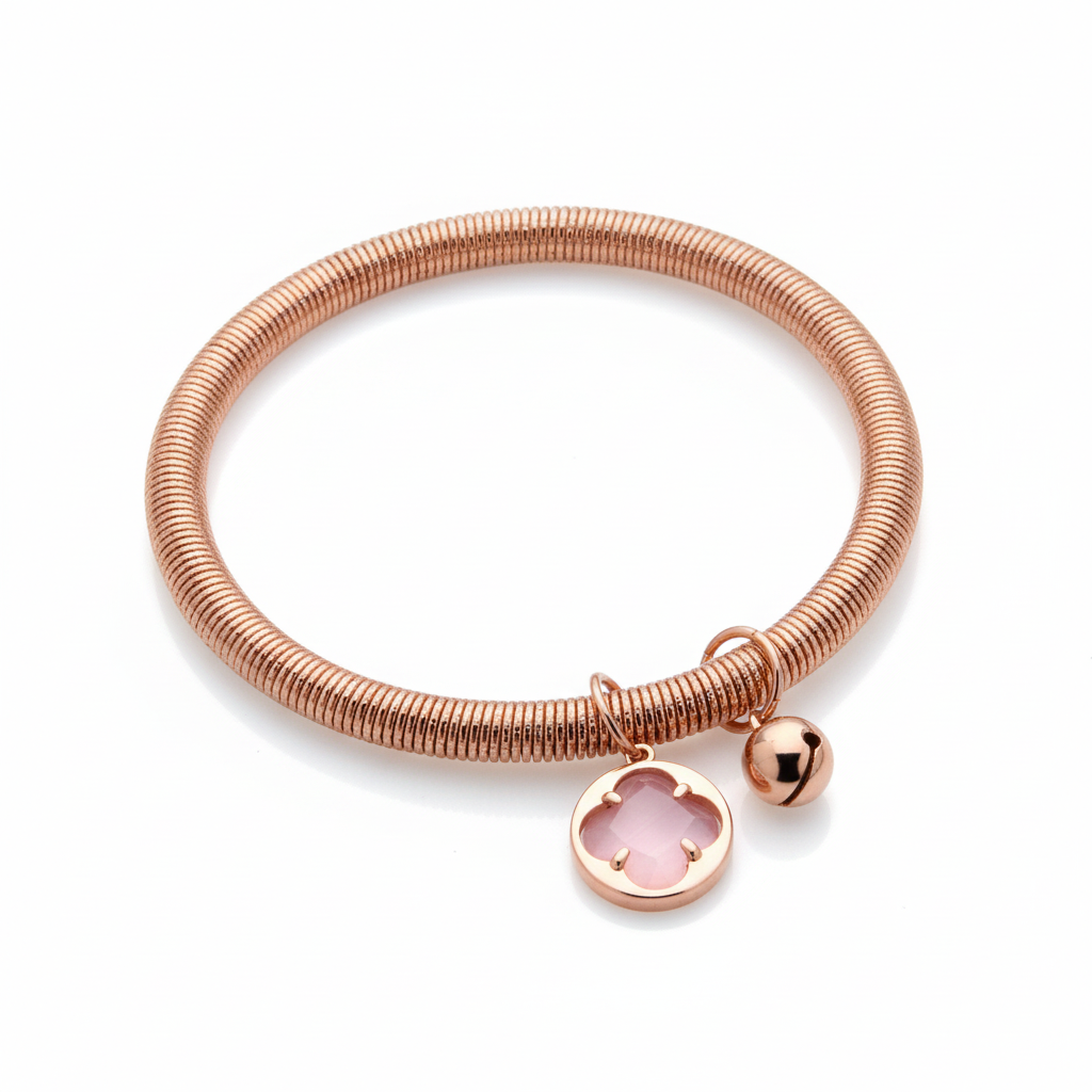 Rose-gold textured stretch bangle bracelet with a light pink four-petal stone charm and round clasp charm on a white background