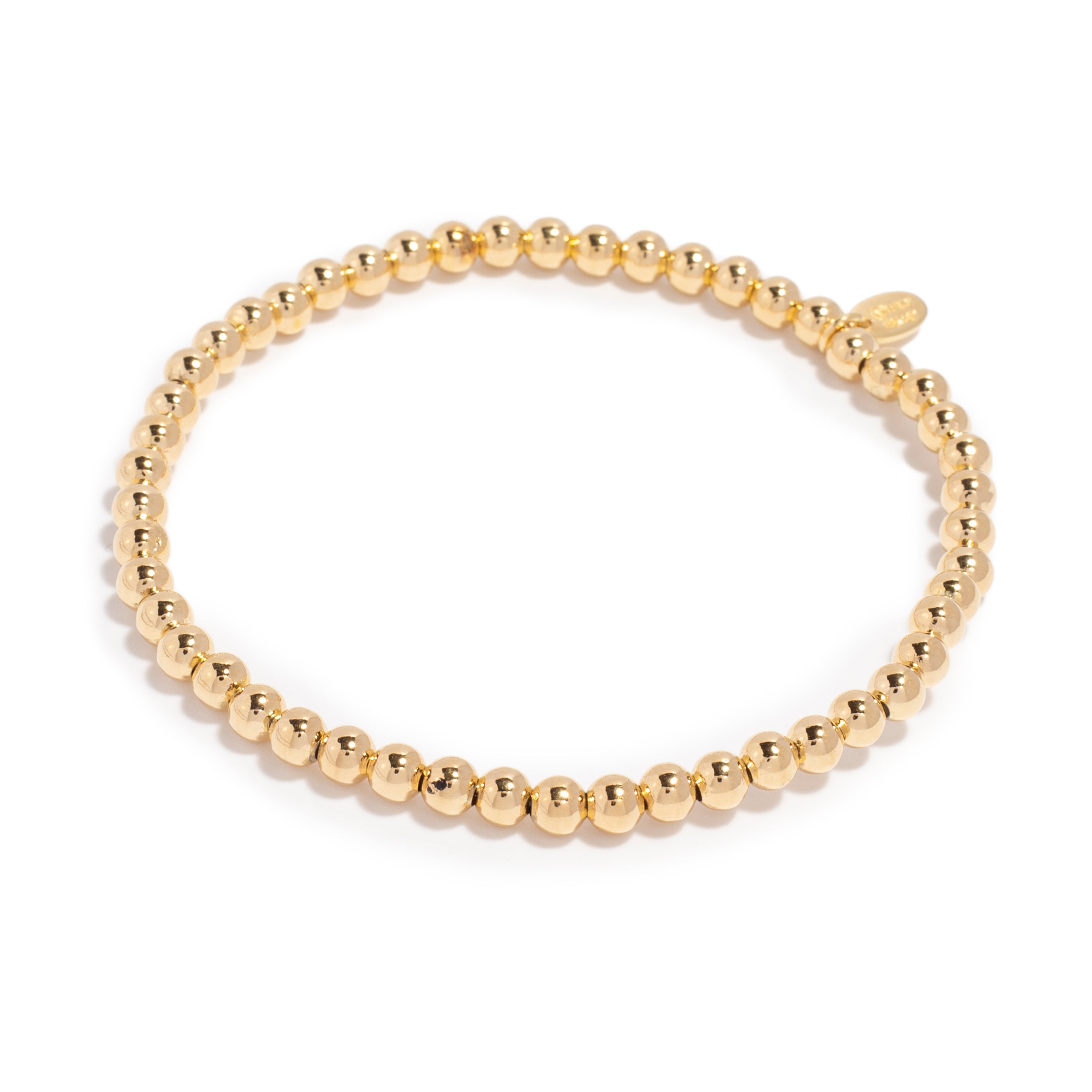 Close-up of a gold bead bracelet featuring a stretchy design made of shiny, round beads, offering a simple and elegant look.