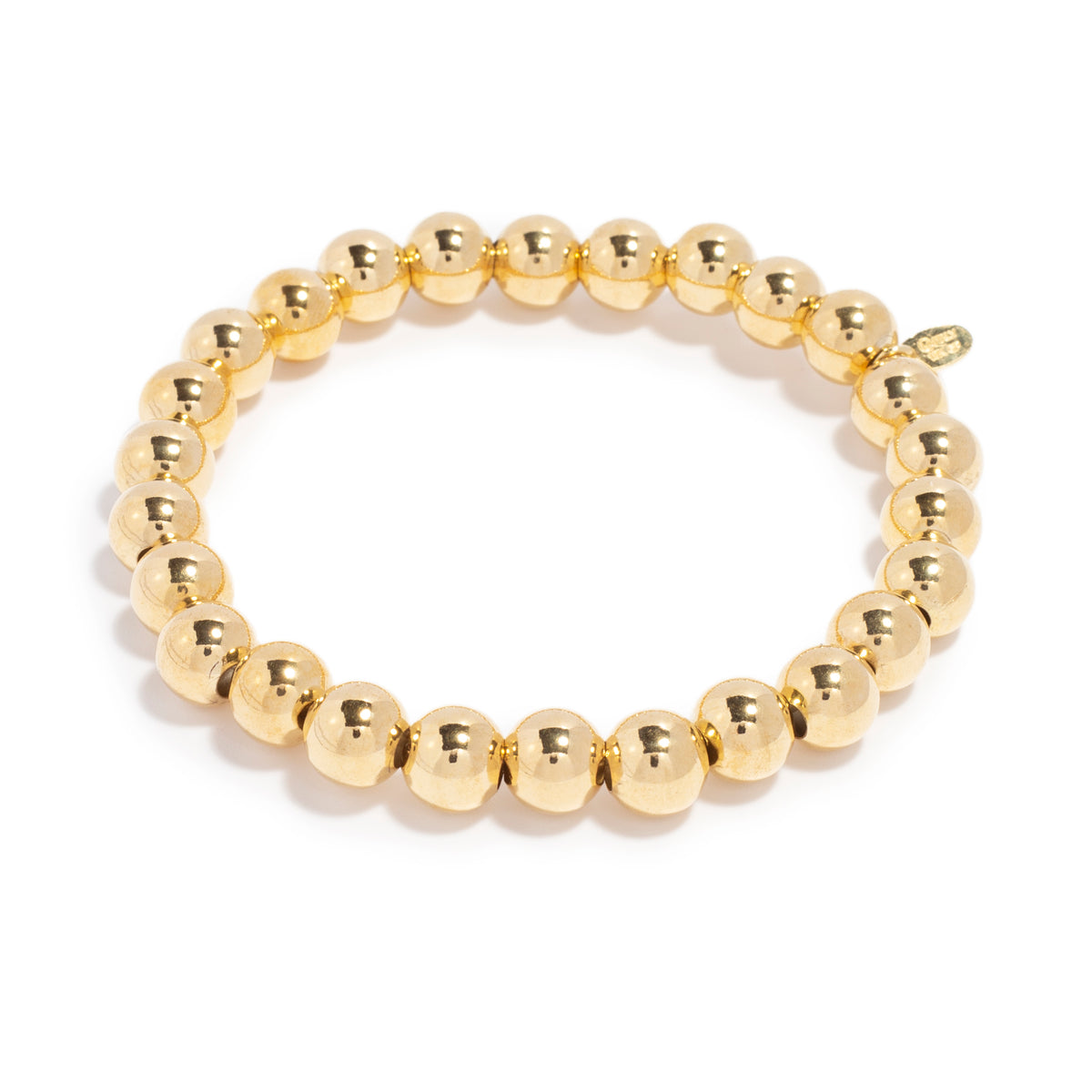 Gold bead bracelet made of shiny, spherical beads strung together on a band, showcasing a smooth and polished finish.