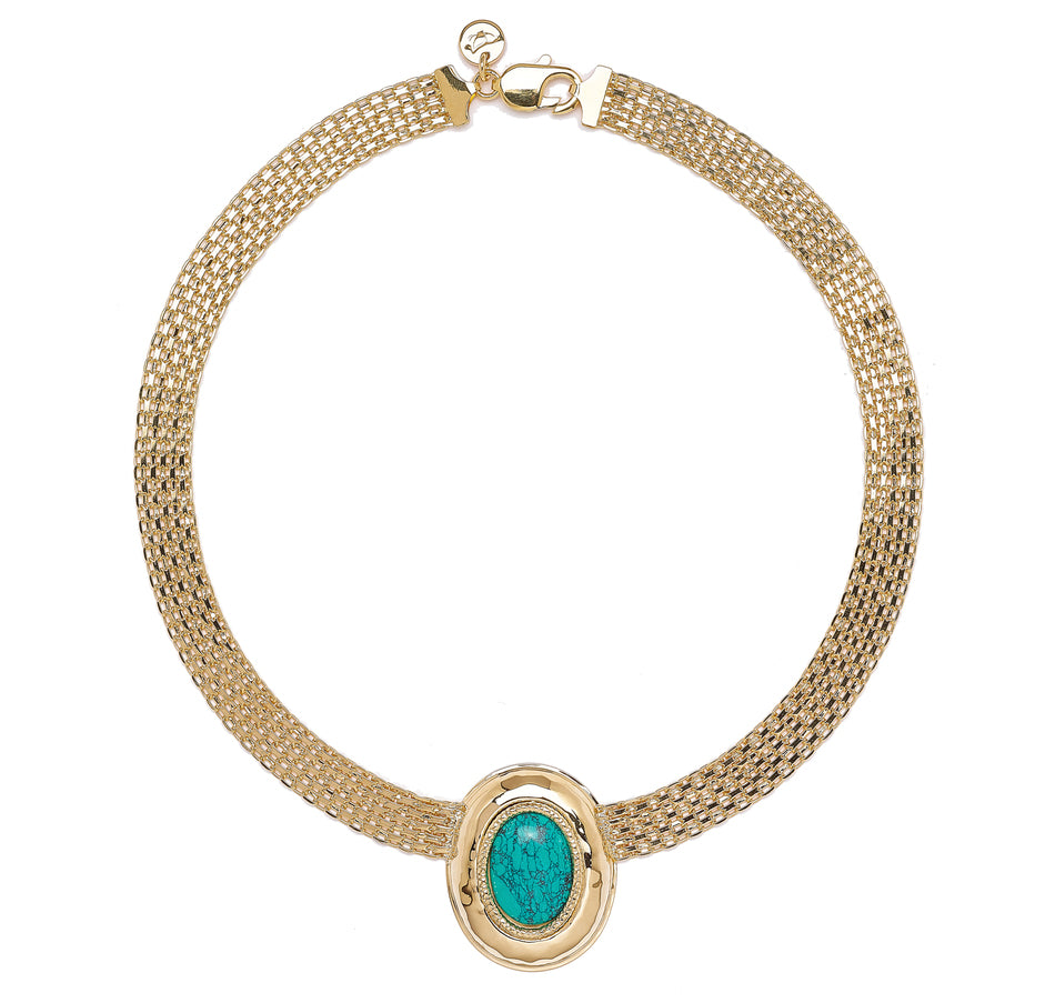 A sophisticated gold necklace featuring a unique design that combines elegance and contemporary style. The necklace has a flexible, mesh-like chain that creates a textured look, tapering toward the center where a striking turquoise stone is set within a polished gold frame. The oval-shaped turquoise stone showcases intricate natural veining, adding depth and character.