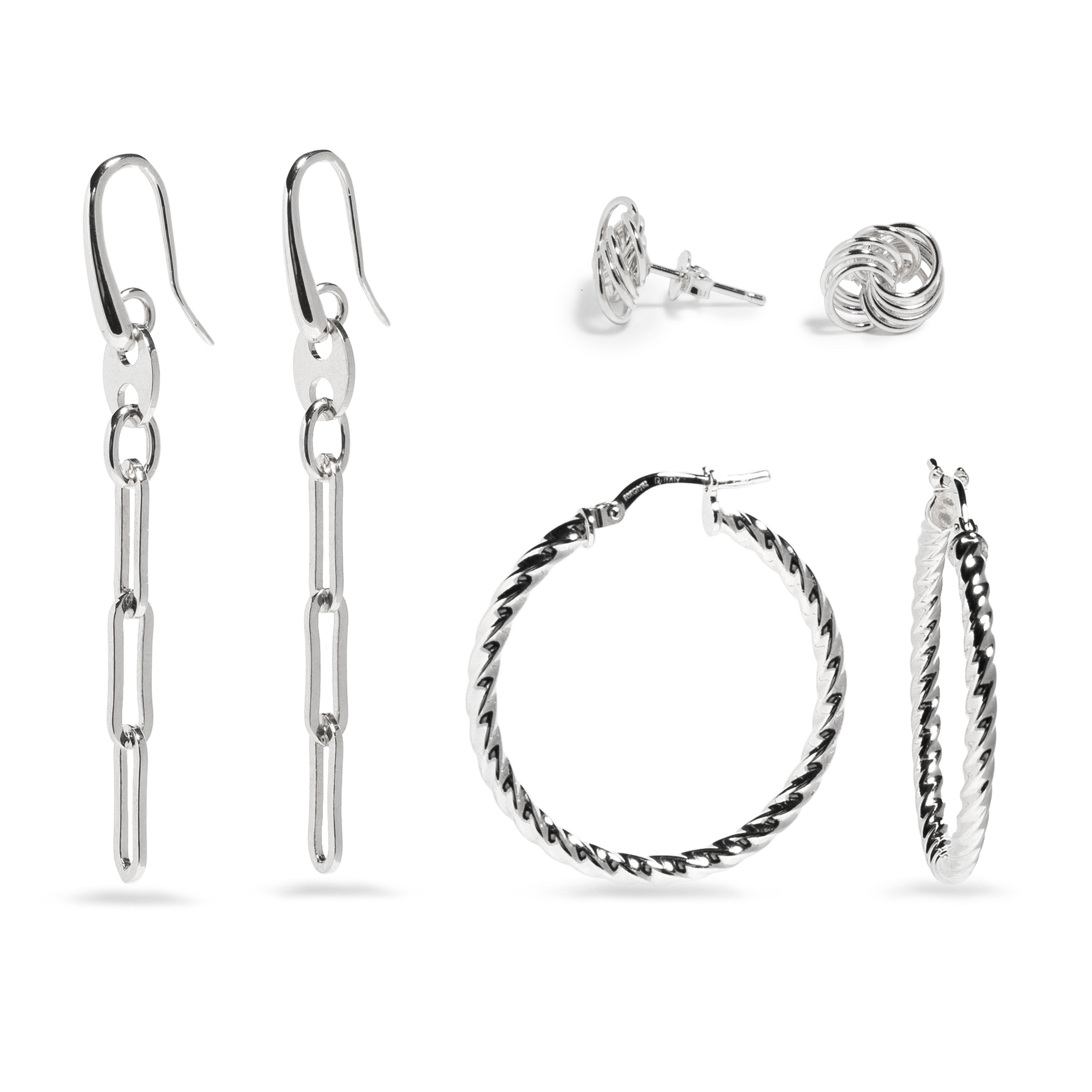 A stylish set of silver earrings featuring two pairs. The first pair consists of sleek, elongated drop earrings with a modern chain-link design, elegantly hanging from fishhook-style clasps. The second pair includes a collection of various stud and hoop earrings: one pair features classic round stud earrings, while two pairs of hoops are showcased—one with a smooth finish and the other twisted for added texture. This versatile set offers a mix of designs that can complement any outfit.
