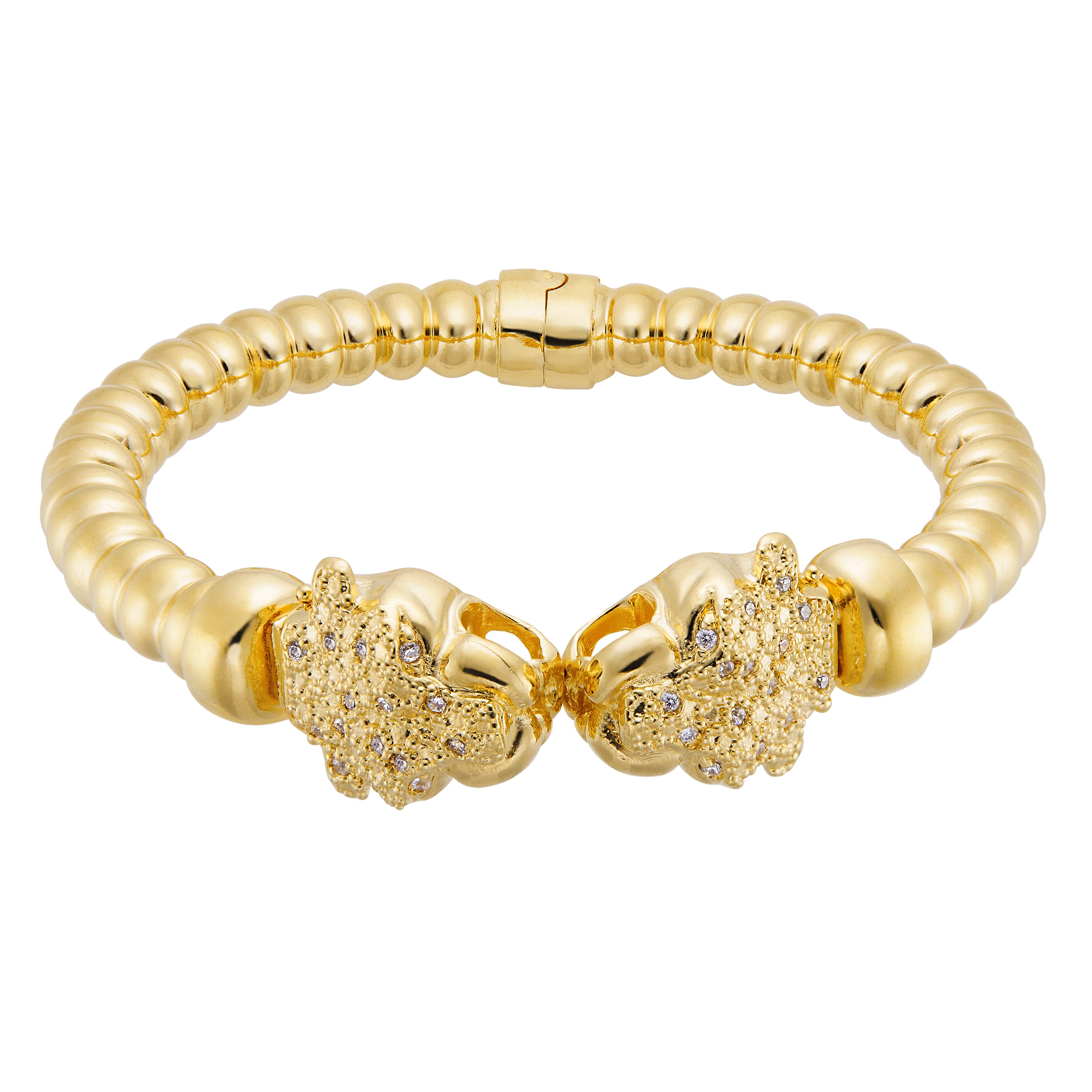 A stylish gold bracelet featuring a flexible band with a ribbed design, giving it a modern, textured appearance. The bracelet is adorned with two lion head clasps, each embellished with sparkling crystals, adding a luxurious touch. This unique piece combines elegance and playful charm, suitable for both casual and formal outfits.