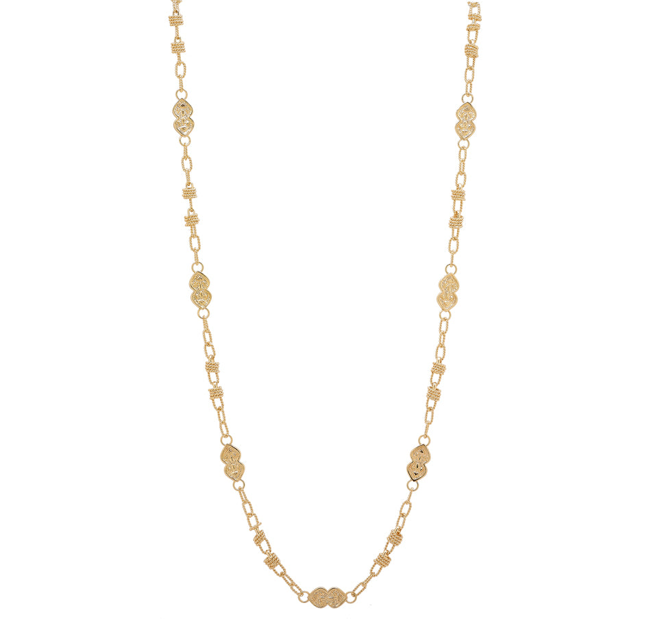 A stylish gold necklace featuring a delicate chain adorned with intricately designed gold links. The necklace showcases alternating decorative elements, including textured and patterned oval shapes, which add a sophisticated touch. The design is elegant and timeless, making it a versatile accessory suitable for both casual and formal outfits. The clasp closure ensures a secure fit, while the overall aesthetic exudes charm and grace.