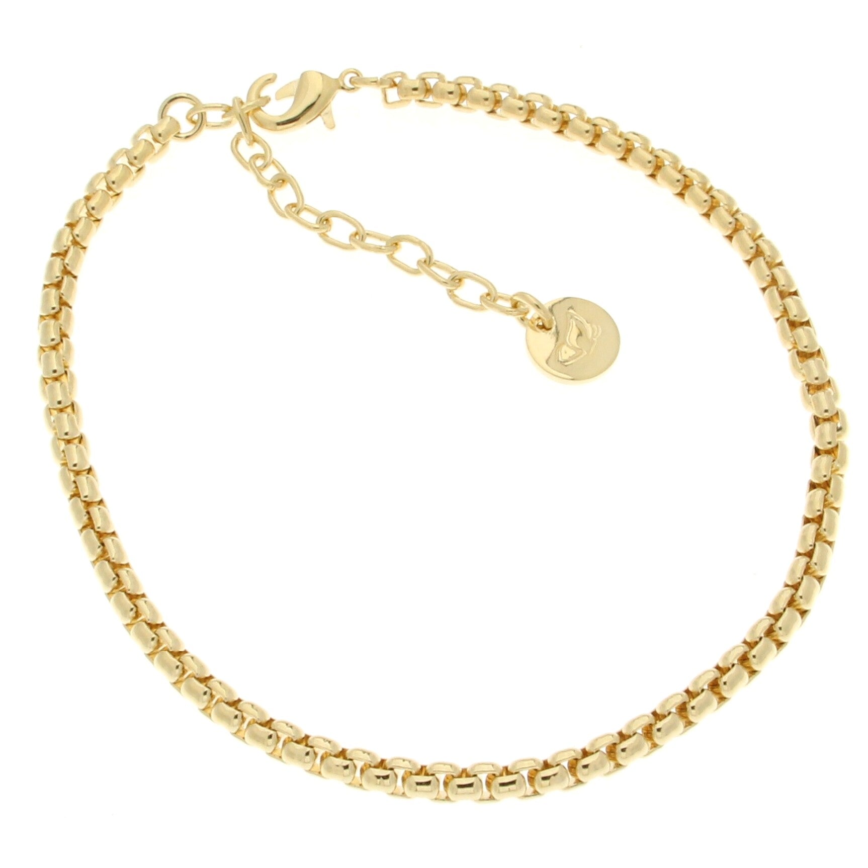 A sleek gold anklet featuring a modern design with interlocking flat links. Adjustable chain extension for a customizable fit, along with a small circular charm displaying a minimalist logo.