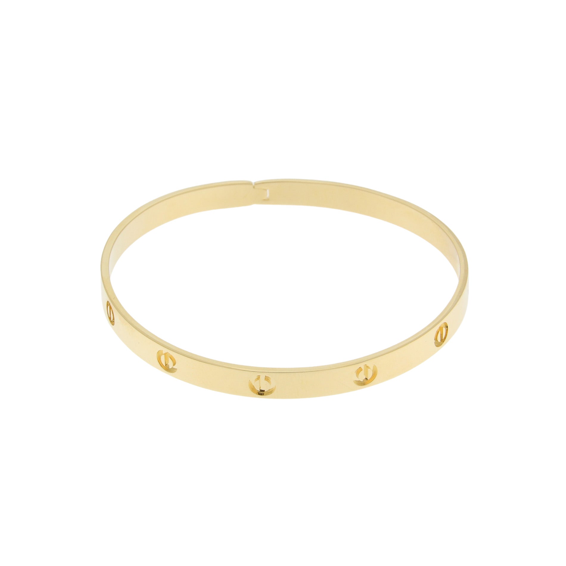 A minimalist gold-tone bangle bracelet featuring evenly spaced cut-out designs along its circumference. The sleek and simple design adds a touch of elegance.