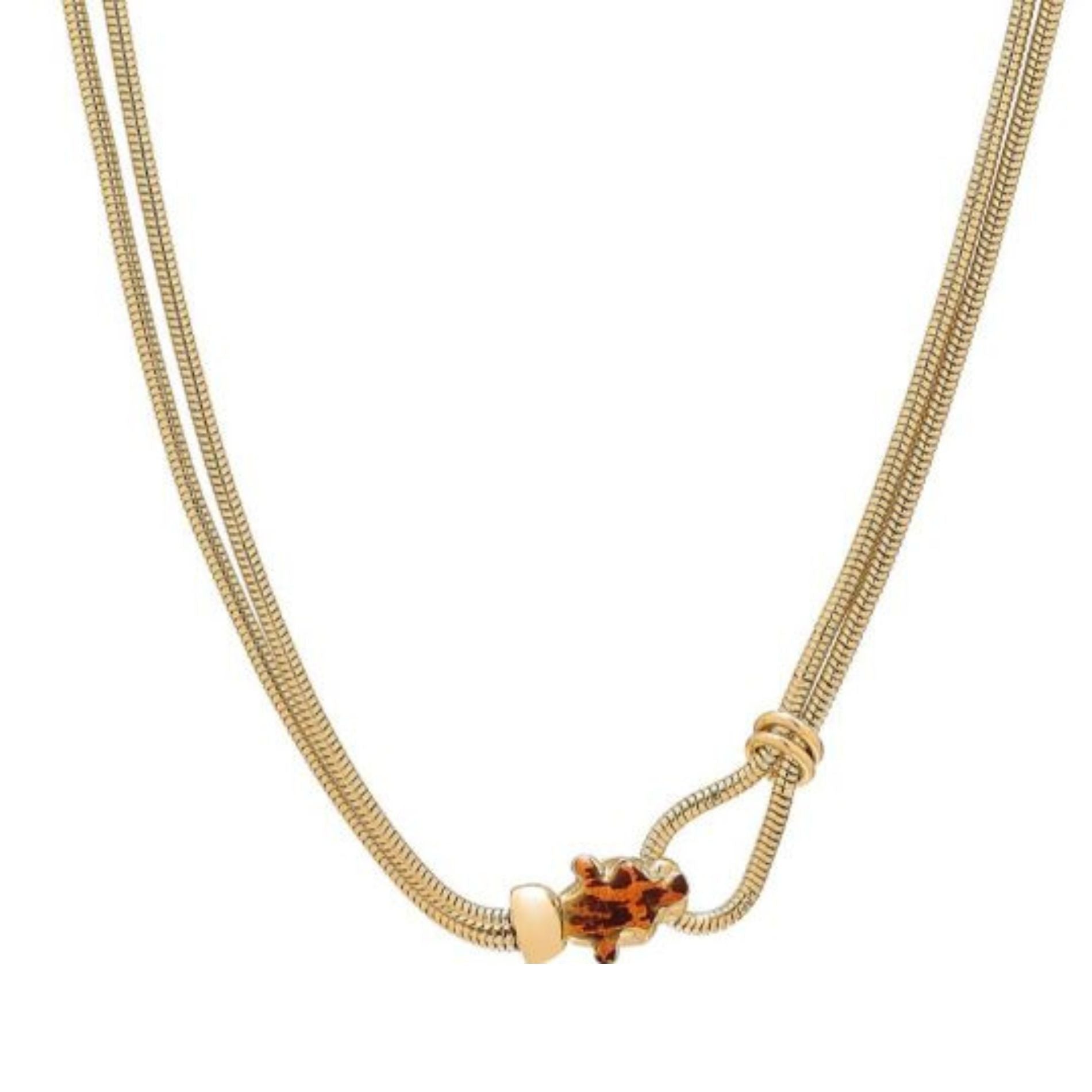 Contemporary gold necklace featuring two sleek chains with a unique tortoise-shaped pendant in amber, showcasing a stylish design with an artistic knot closure.