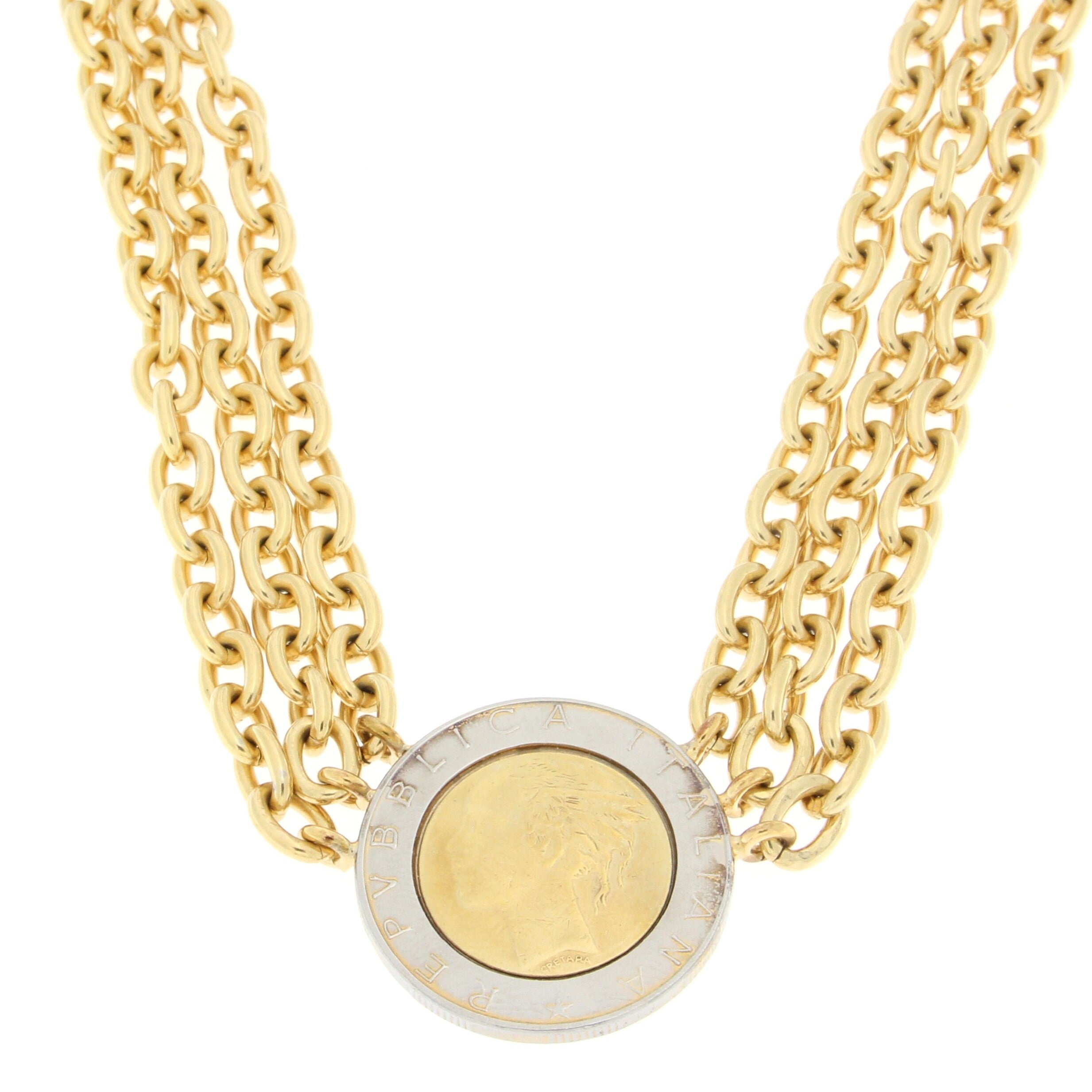 Bold gold necklace featuring multiple thick chains with a central coin pendant showcasing a profile image and engraved border, combining classic and contemporary design elements.