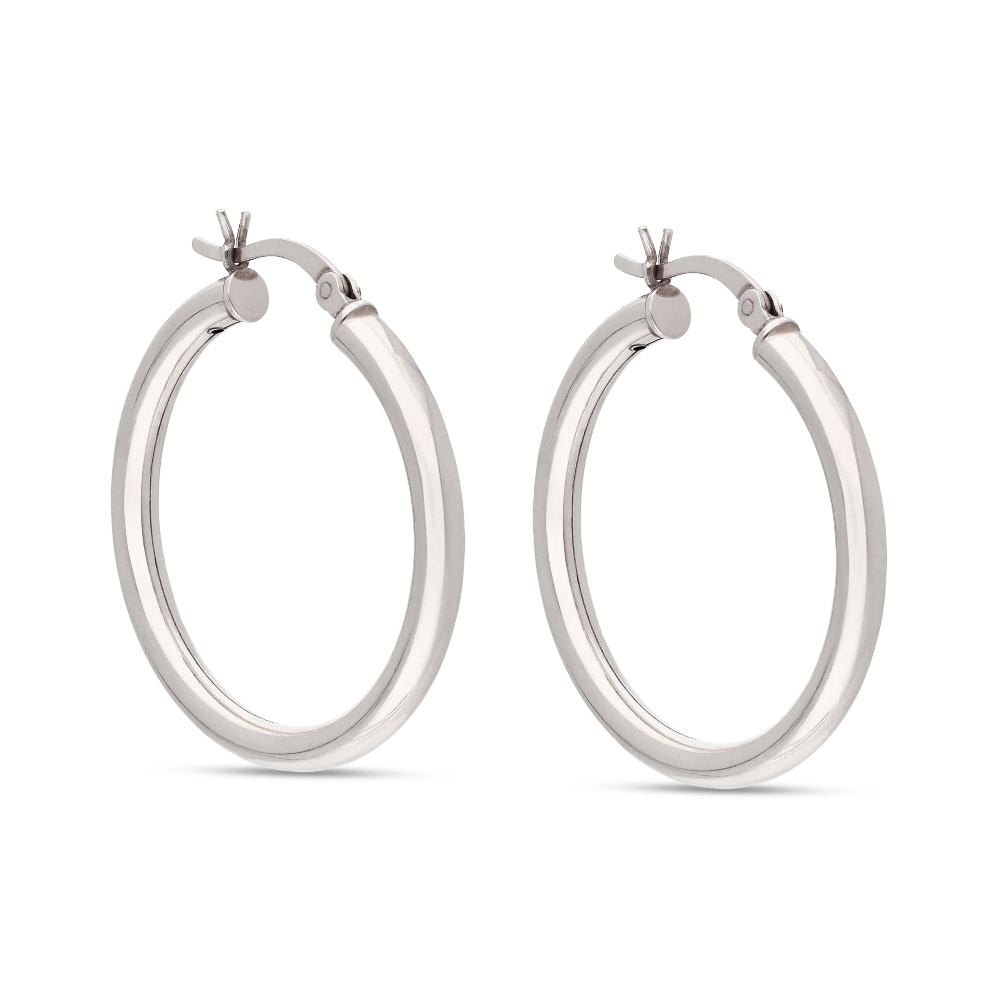 Sleek silver-tone hoop earrings with a modern design. These earrings feature a smooth, polished surface that reflects light beautifully. The secure latch closure ensures they remain comfortably in place, making them a stylish choice for both casual and formal occasions.