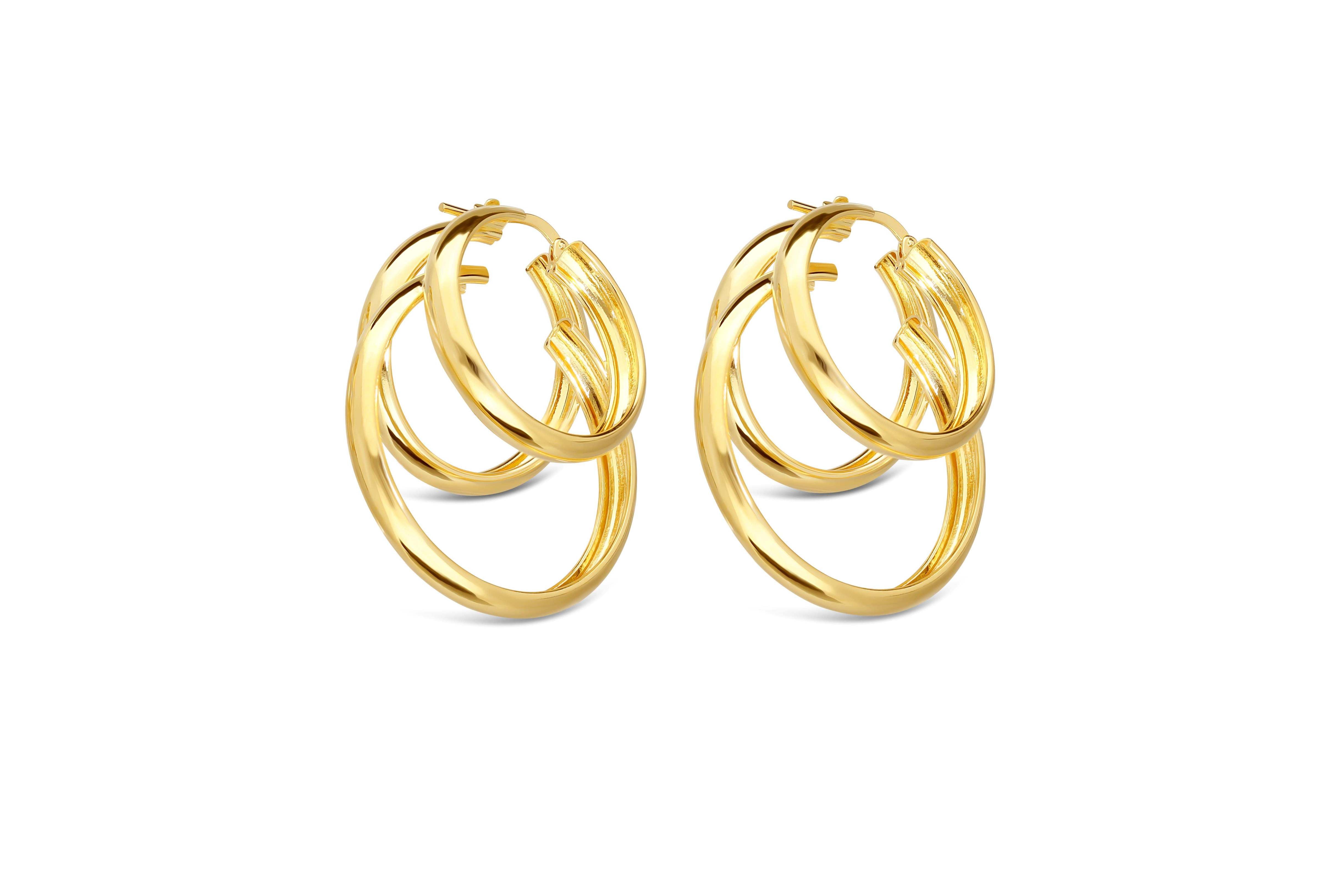 Stylish gold-tone hoop earrings featuring a layered design with multiple interlocking hoops. The earrings showcase a shiny finish that adds elegance and dimension, making them a versatile accessory.