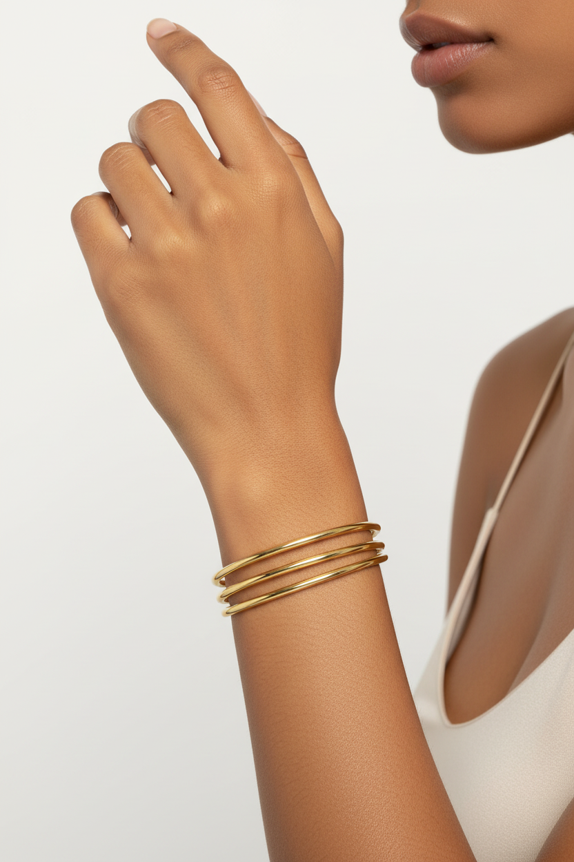 Diverse model wearing gold bangle set