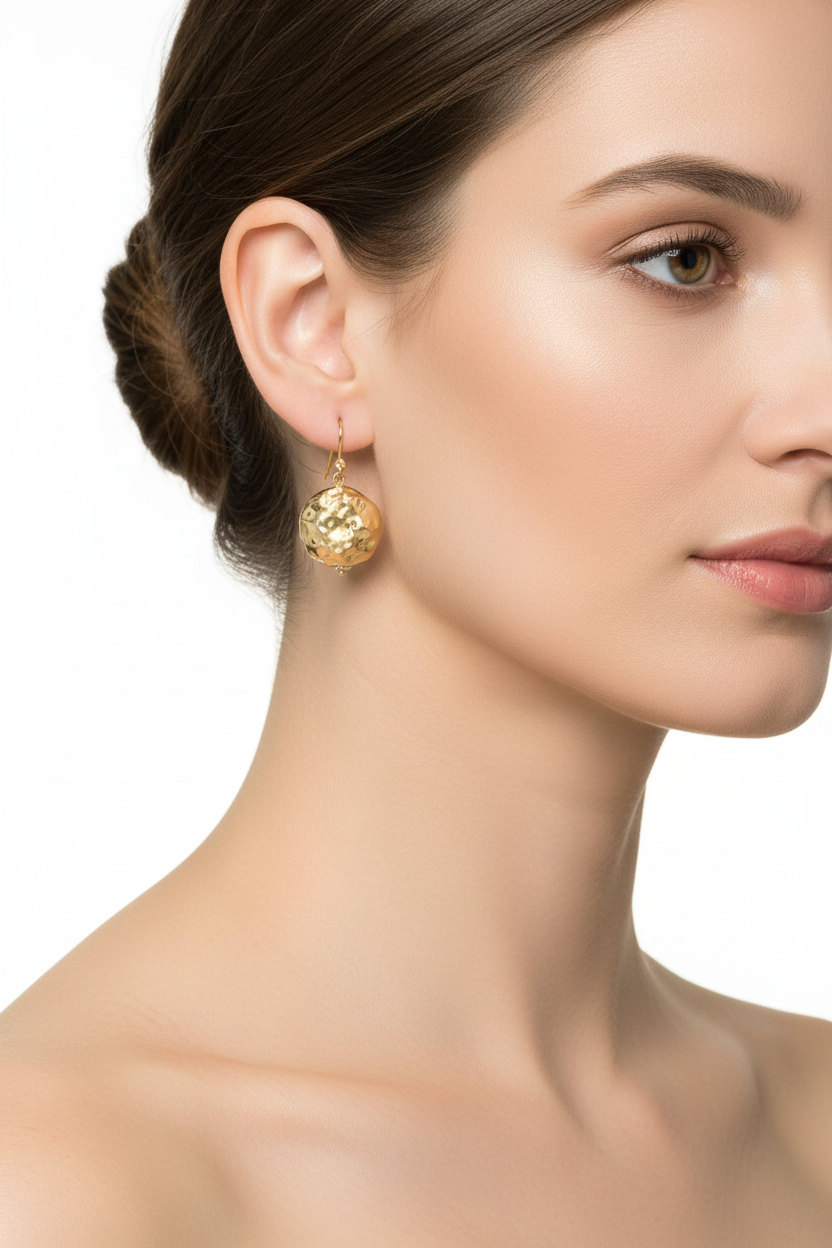 Gold hammered bead drop earrings on model