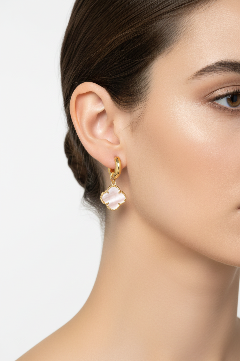 Gold hoop earrings with pink clover drops on model
