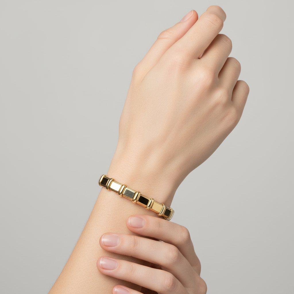 Gold rectangular link cuff bangle on gender-neutral model's wrist