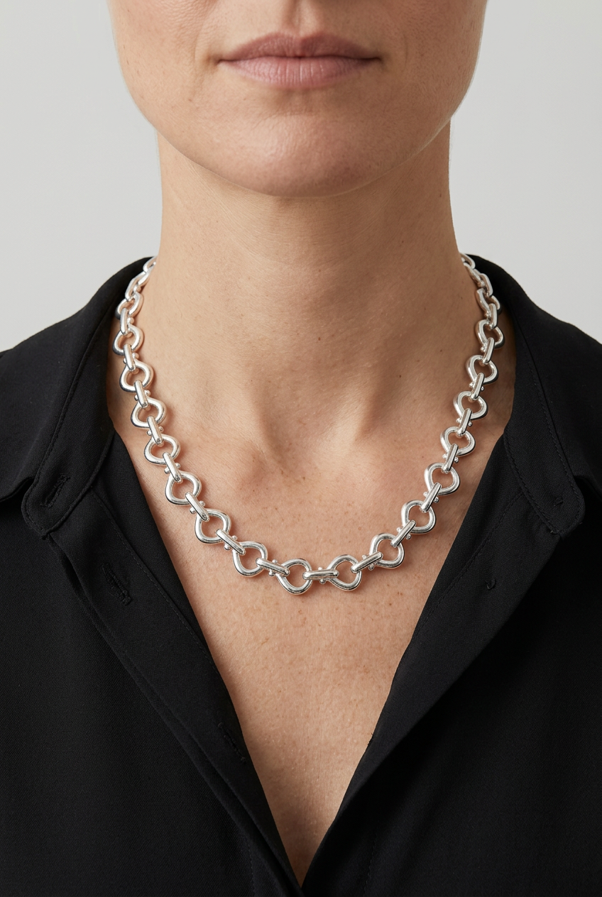 Model wearing the silver necklace with a black blouse
